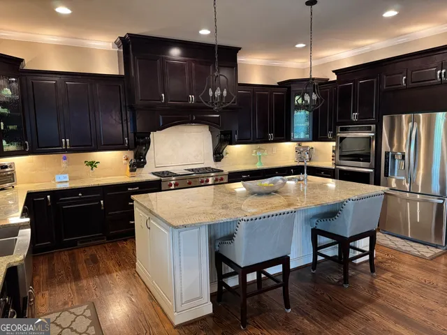 a kitchen with a table chairs sink and cabinets