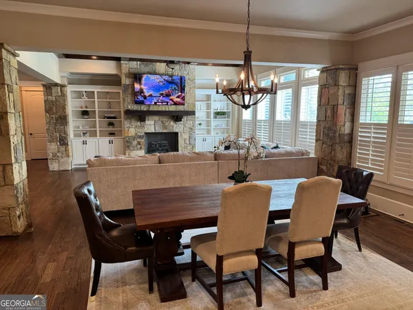 a living room with furniture a flat screen tv and kitchen view