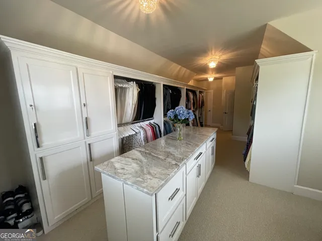 a kitchen with granite countertop a sink and a refrigerator