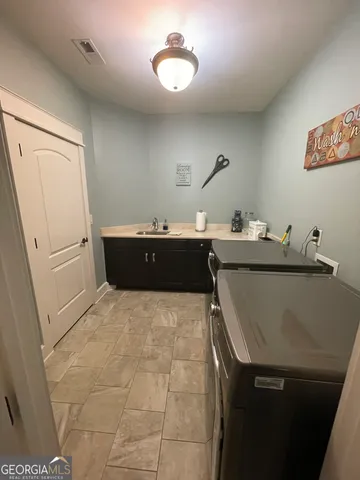 a room with a sink and cabinets