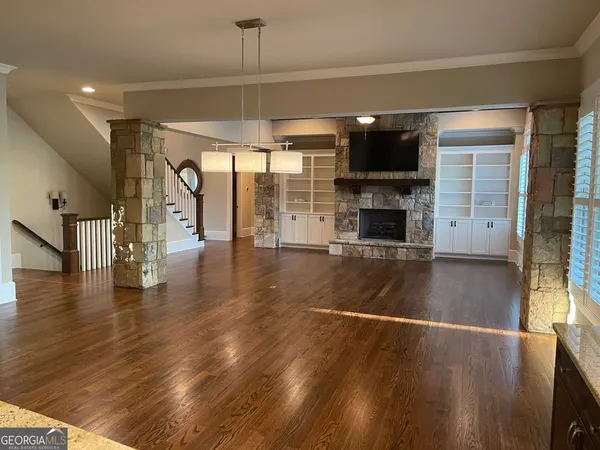 a bathroom with a granite countertop toilet and a sink