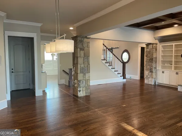 a view of a hallway with furniture and a chandelier