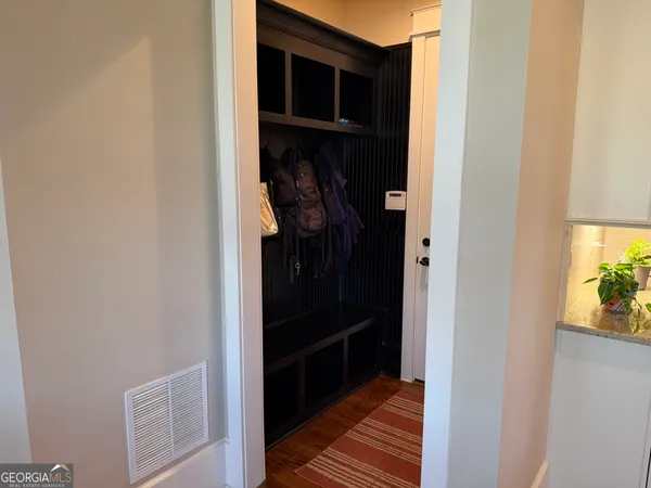 a bedroom with a bed and a lamp on the dresser