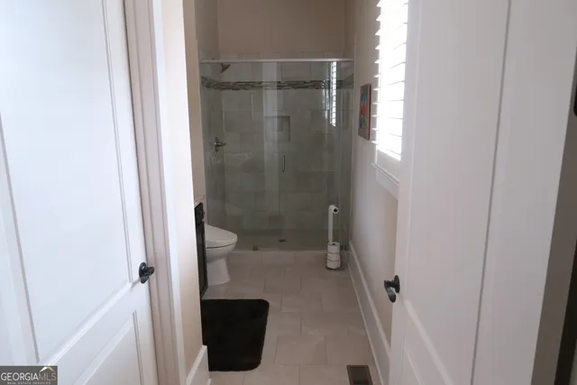 a bathroom with a shower and toilet
