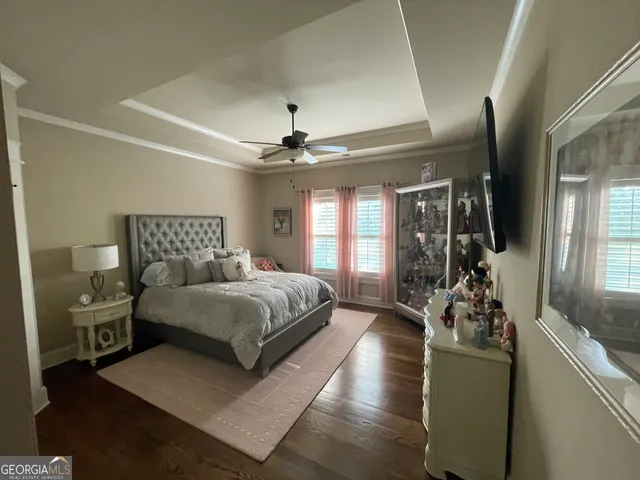 a bedroom with a large bed and a chandelier