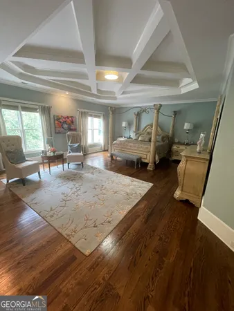 a bedroom with a large bed and a chandelier
