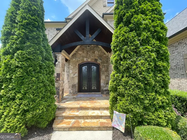 a front view of a house with a garden