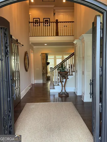 a view of entryway and hall with wooden floor