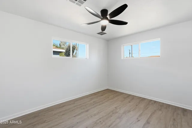 a view of an empty room with wooden floor