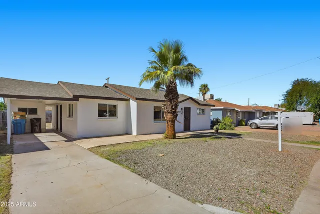 a house that has a tree in front of it