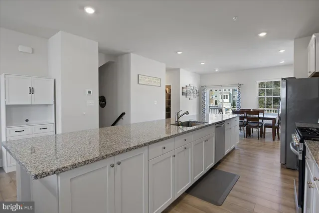 a large kitchen with granite countertop lots of counter space and a sink