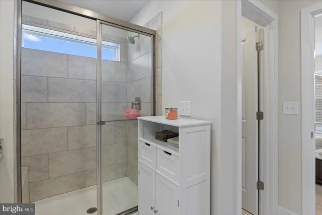a bathroom with a bathtub and a shower