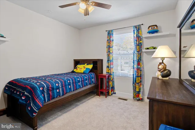 a bedroom with bed and a chandelier