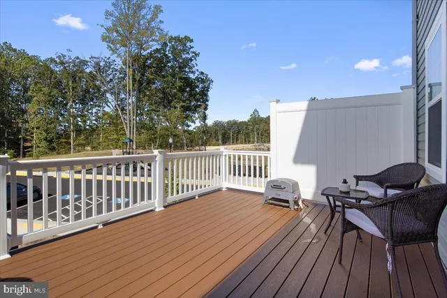 a balcony with hardwood filled with furniture and wooden floor