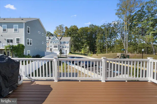 a balcony with wooden floor and fence