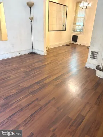 a view of a room with wooden floor and window