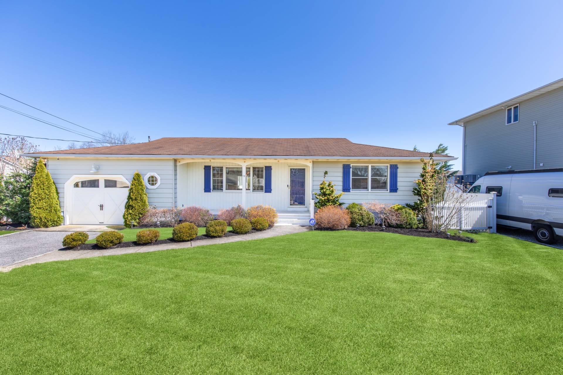 a view of a house with a big yard and potted plants