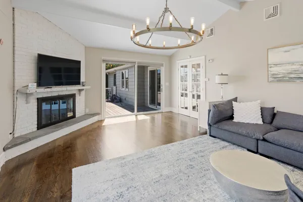 a living room with furniture a flat screen tv and a fireplace