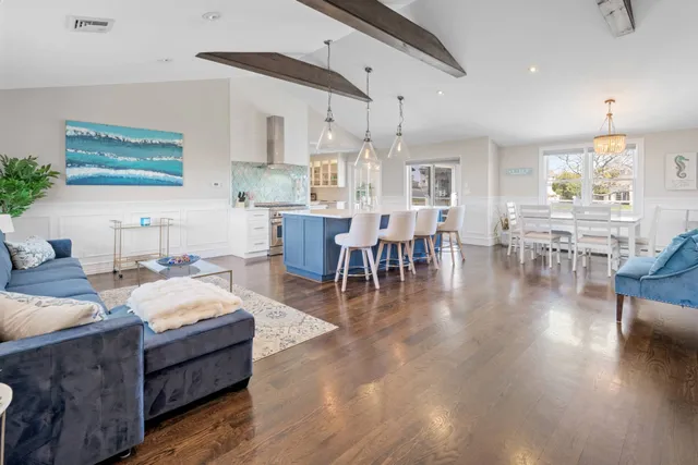 a living room with furniture dining table and wooden floor