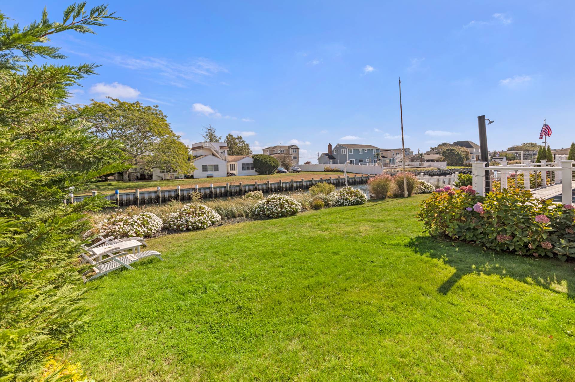 13 Marlin Road East Quogue, NY 11942 - Photo 21 of 22 a view of a garden with a building in the background