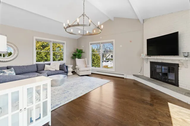 a living room with furniture a flat screen tv and a fireplace