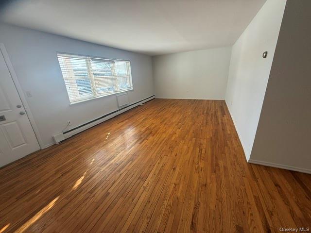 54 Ralph Avenue Babylon, NY 11702 - Photo 5 of 6 wooden floor in an empty room with a window