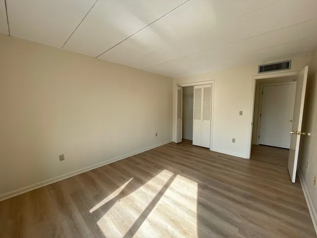 a view of an empty room and wooden floor