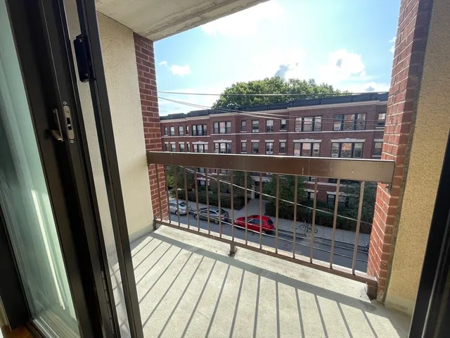 a view of a balcony with car park