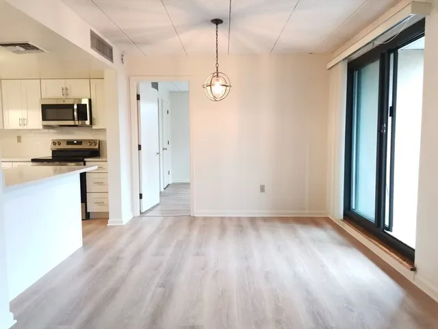 a view of a kitchen with a sink dishwasher and a refrigerator