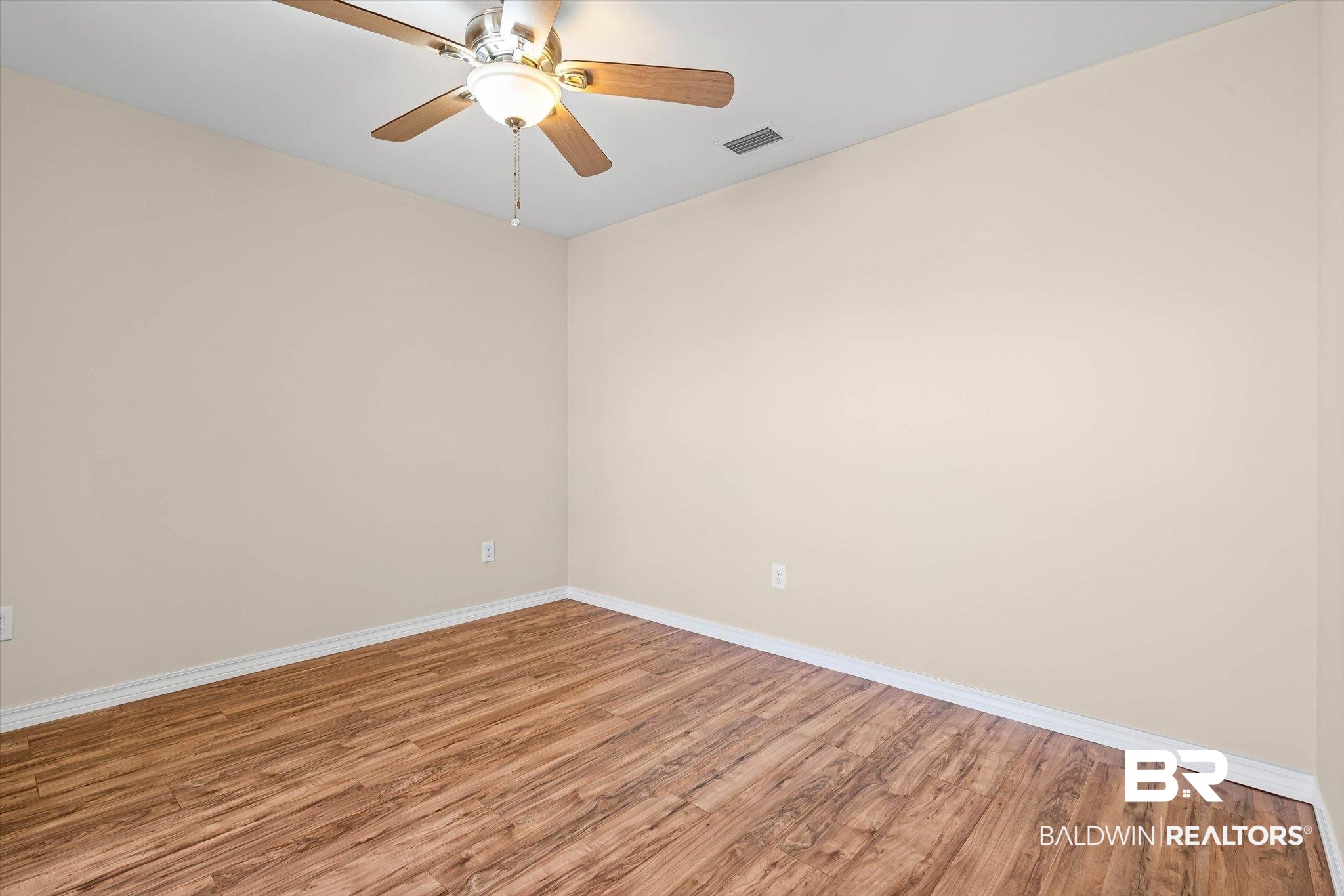 919 Sailor Circle Foley, AL 36535 - Photo 15 of 24 Spare room featuring wood finished floors and a ceiling fan