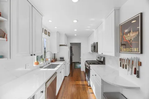 a kitchen with stainless steel appliances sink stove and refrigerator