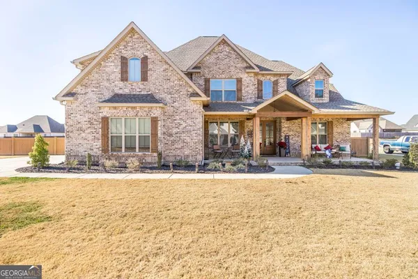 a front view of a house with yard and patio