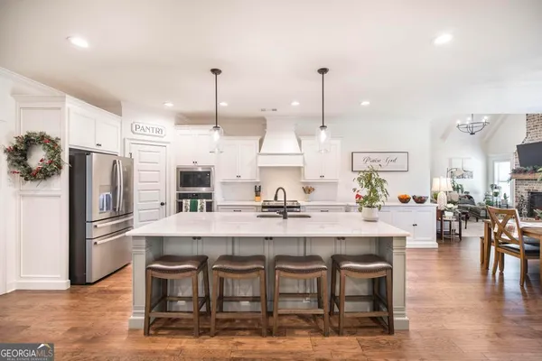 a large kitchen with a table and chairs