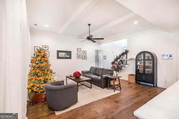 a living room with furniture and a chandelier