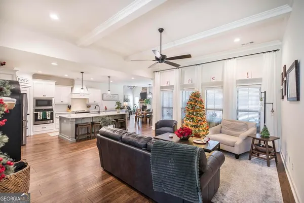 a living room with furniture and kitchen view