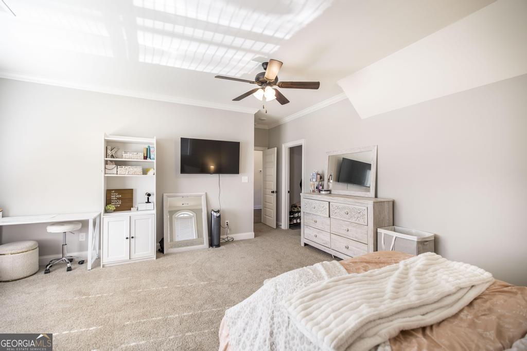206 Bristleleaf Path Kathleen, GA 31047 - Photo 27 of 33 a bedroom with a bed flat screen tv and a chandelier