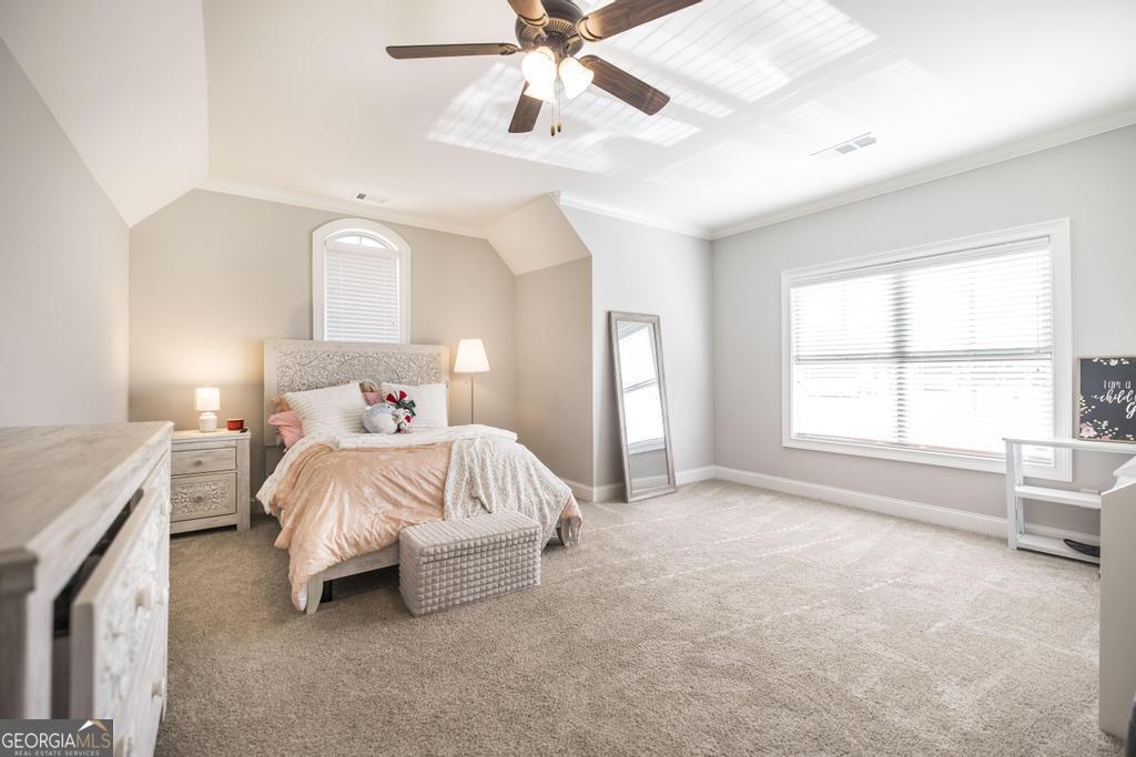206 Bristleleaf Path Kathleen, GA 31047 - Photo 28 of 33 a spacious bedroom with a bed and a chandelier