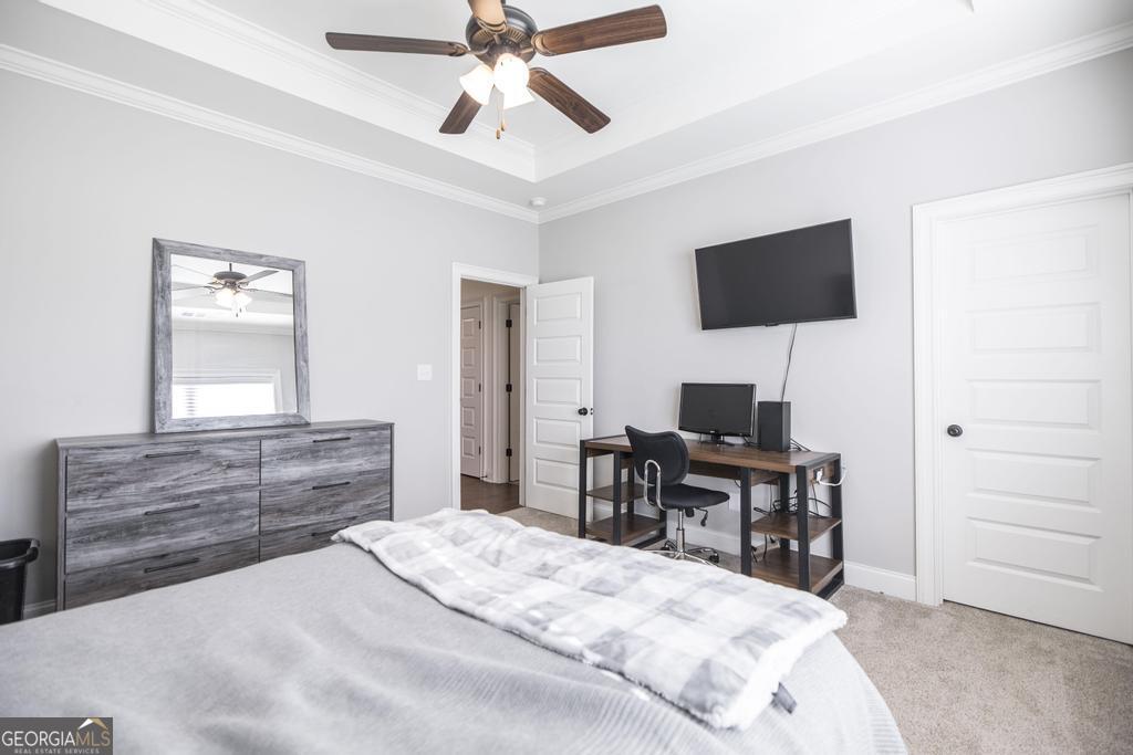 206 Bristleleaf Path Kathleen, GA 31047 - Photo 29 of 33 a bedroom with a bed and a flat screen tv