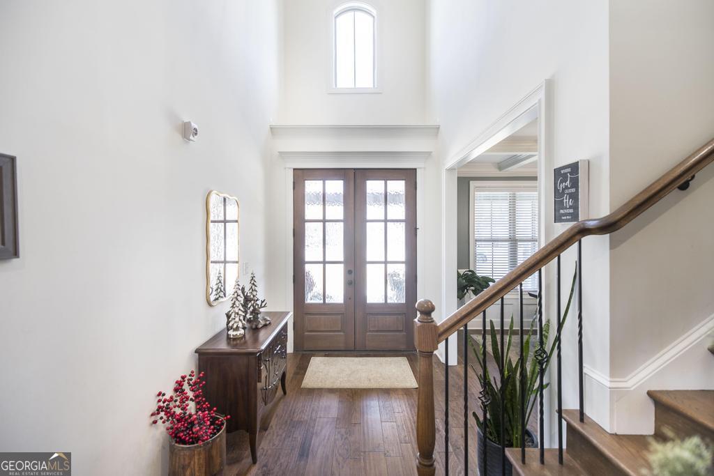 206 Bristleleaf Path Kathleen, GA 31047 - Photo 4 of 33 a hallway with wooden floor chandelier and entryway