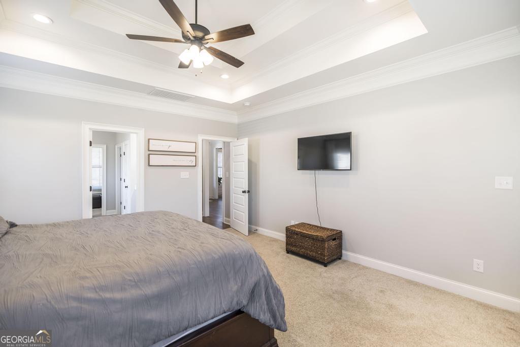 206 Bristleleaf Path Kathleen, GA 31047 - Photo 7 of 33 a bedroom with a bed and a flat screen tv