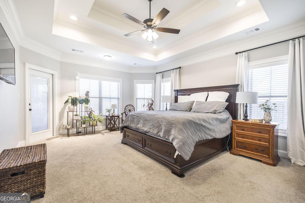 206 Bristleleaf Path Kathleen, GA 31047 - Photo 8 of 33 a spacious bedroom with a bed ceiling fan and a window