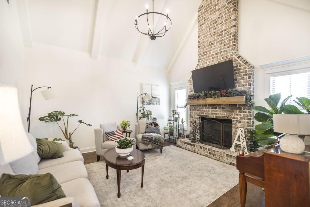 206 Bristleleaf Path Kathleen, GA 31047 - Photo 9 of 33 a living room with furniture a fireplace and a flat screen tv