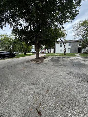 a tree is standing in front of a house