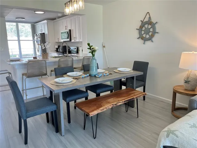 a view of a dining room with furniture wooden floor and a chandelier