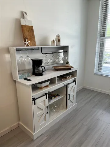 a kitchen with stainless steel appliances a table and chairs