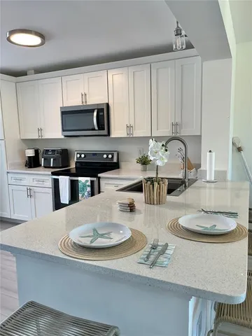 a kitchen with a dining table and chairs
