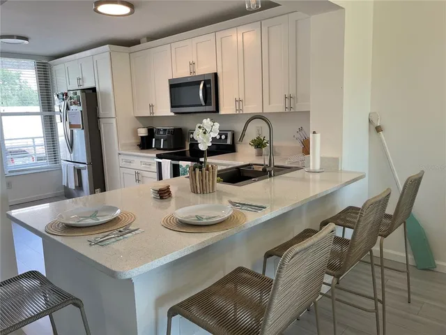 a kitchen with a sink appliances and cabinets
