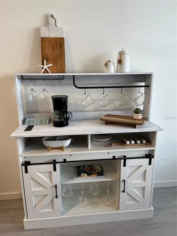 a kitchen with stainless steel appliances a table and chairs