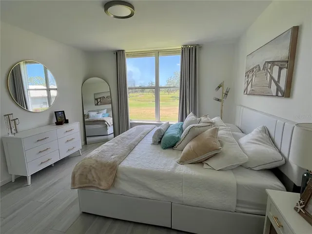 a bed sitting in a bedroom next to a window