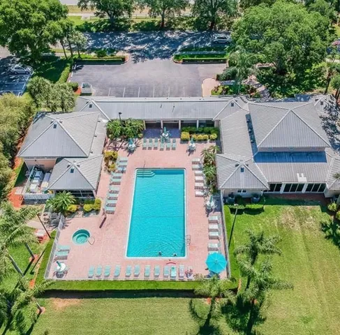 an aerial view of a house with a garden and swimming pool